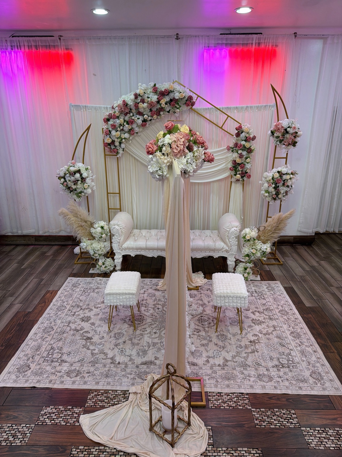 Elegant ivory and blush Nikkah stage with floral installations and gold accents by Arinay Events