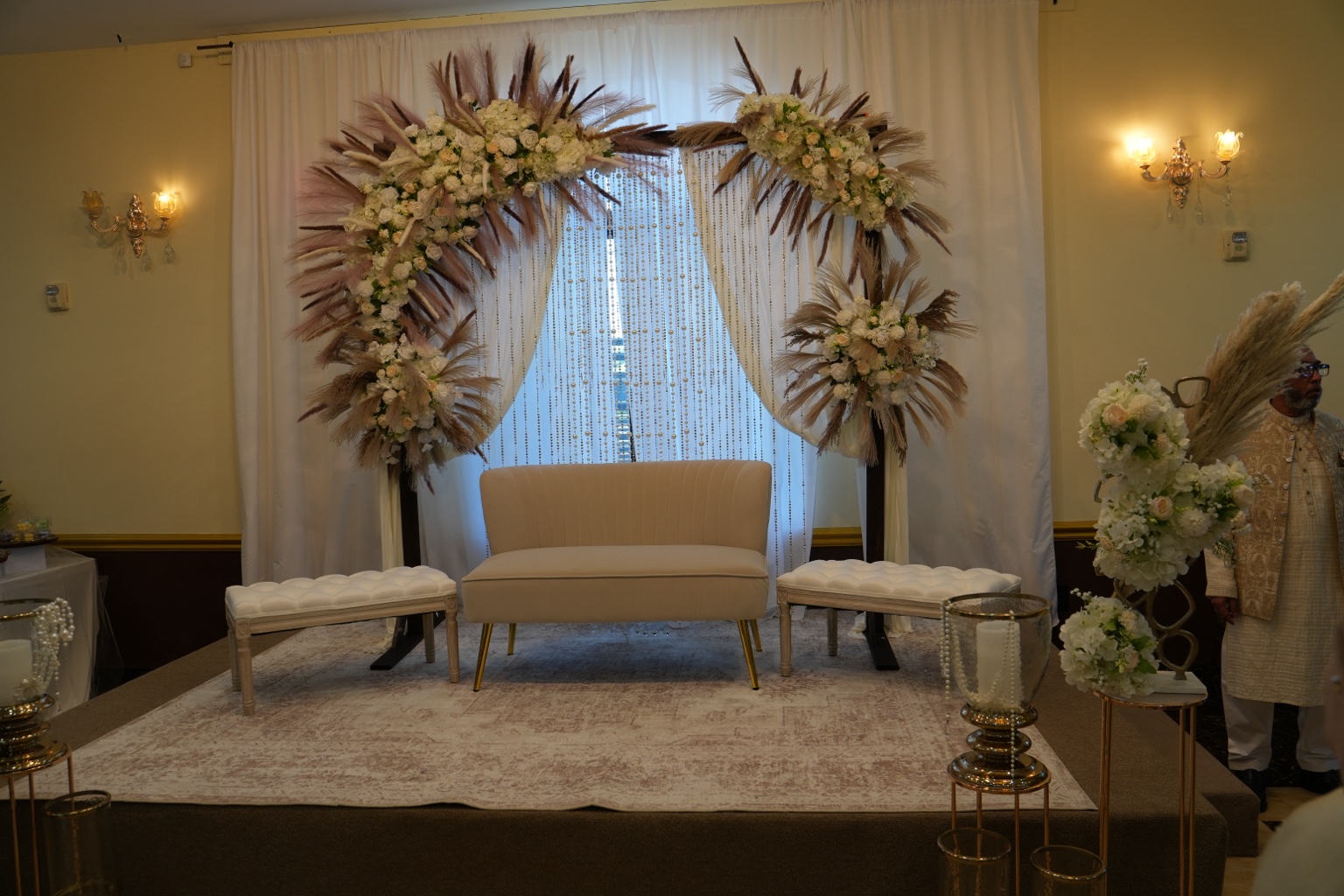 Ivory Nikkah stage with white florals, pampas grass, draping and pearl details by Arinay Events